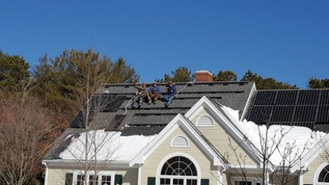 Solar workers on top of a residential home.