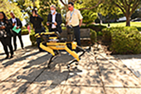 Atkins Robotics Engineer Kevin Maze shows EM Acting Assistant Secretary William "Ike" White how to operate the Spot quadruped robot during a recent visit to Catholic University’s Vitreous State Laboratory.