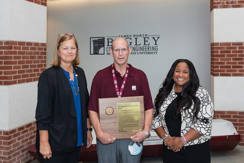 Charles Waggoner, center, former director of Mississippi State University’s (MSU) Institute for Clean Energy Technology, has been recognized with DOE’s Distinguished Career Service Award. MSU Vice President for Research and Economic Development Julie Jordan, left, and EM Associate Principal Deputy Assistant Secretary for Field Operations Nicole Nelson-Jean presented Waggoner with the award last week.
