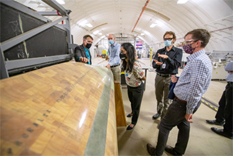 Center Director at the National Wind Technology Center (NWTC), discusses wind turbine blade research with David M. Turk, U. S. deputy secretary of energy, and Arpita Bhattacharyya, chief of staff to the deputy secretary of energy, during a tour of the Composites Manufacturing Education and Technology (CoMET) Facility at NREL.