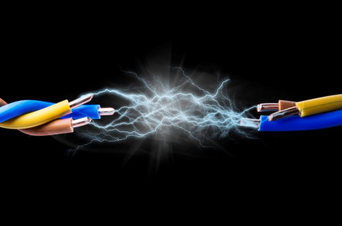 An image of a cable, cut in half, with sparks arcing between the two halves.