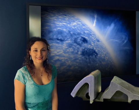 Livia Casali of General Atomics stands with the Small Angle Slot (SAS) divertor model. Casali and her team combined the SAS configuration with impurity injection to improve integration between the hot core of a plasma and the cooler edge.