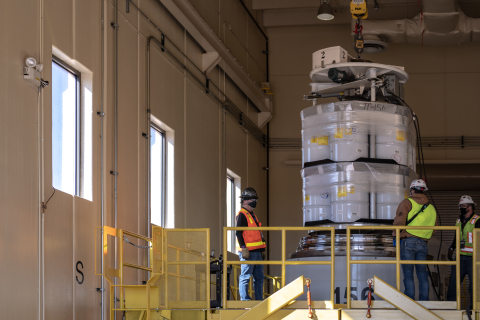 Workers at the Radioassay and Nondestructive Testing facility at the Los Alamos National Laboratory load the first comingled transuranic waste shipment from EM and the National Nuclear Security Administration.