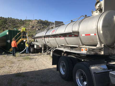 EM crews at Los Alamos National Laboratory empty purged well water into a truck for offsite disposal.