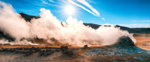a photo of a steam vent in the desert.