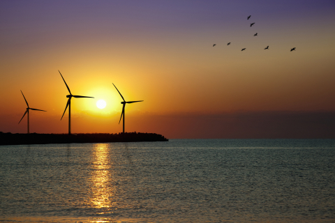Wind turbine against a sunset.