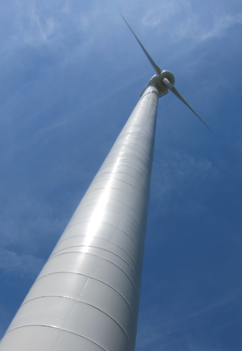 View looking up at a tall wind turbine tower.