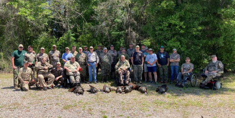Hunters in the 17th Annual Wounded Warrior and Mobility Impaired Wild Turkey Hunt gather post-hunt. Photo courtesy of the U.S. Department of Agriculture.