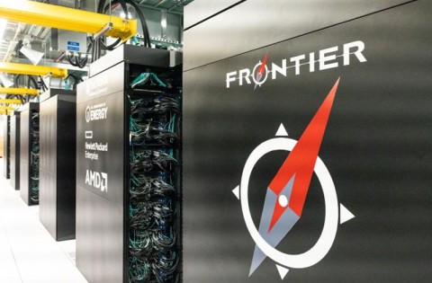 Rows of black computing cabinets with many wires and a red and white compass logo reading FRONTIER on the closest cabinet