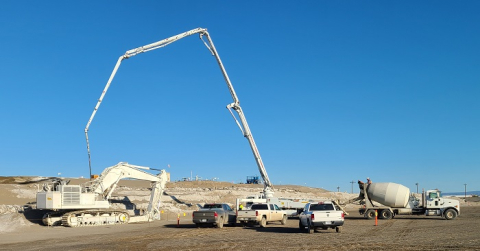 Workers with EM contractor Central Plateau Cleanup Company prepare a retired excavator for disposal at the Hanford Site’s Environmental Restoration Disposal Facility (ERDF).