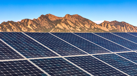 This is a graphical image of a solar array in front of a mountain range.
