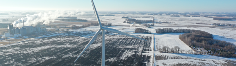 Distributed wind turbine with facility on a snowy day.