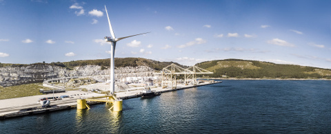 Aerial view of a wind turbine at a dock.