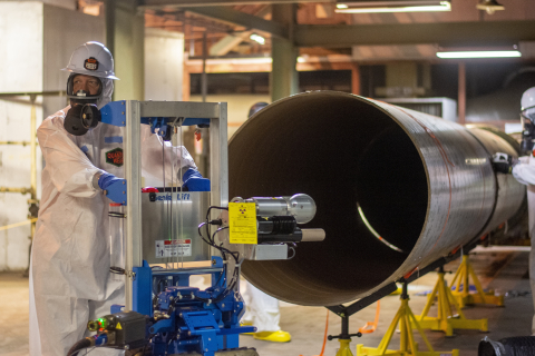 Kevin Fortner with EM Paducah Site cleanup contractor Four Rivers Nuclear Partnership sets up the robot pipe crawler to test its capabilities.