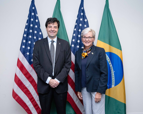 Brazilian Minister of Mines and Energy Adolfo Sachsida and Secretary of Energy Jennifer Granholm stand in front of American and Brazilian flags at the U.S. Chamber of Commerce during the the inaugural meeting of the United States-Brazil Clean Energy Industry Dialogue (CEID).