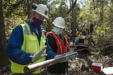 Savannah River Nuclear Solutions environmental engineers examine a soil sample obtained through use of a drill rig at the Savannah River Site.