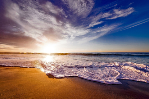 Sunset over the ocean and beach.