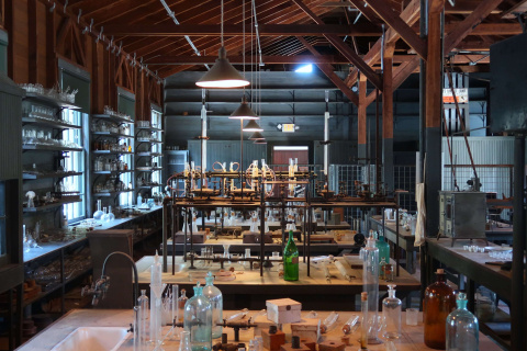 a photo of a lab, with tables covered in glass vials.