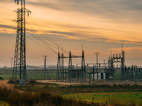 Transmission lines and a transformer station at sunset