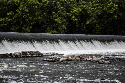 A wide waterfall over a dam