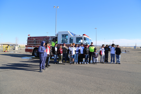 Students from Chiawana High School in Pasco, Washington stand alongside a Hanford Fire Department fire engine at the Volpentest HAMMER Federal Training Center, during STEM Day at the Hanford Site.