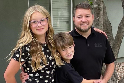 A portrait of Anthony George and his two children