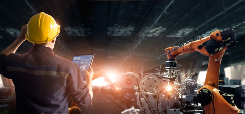 a picture of a person looking at a robotic arm
