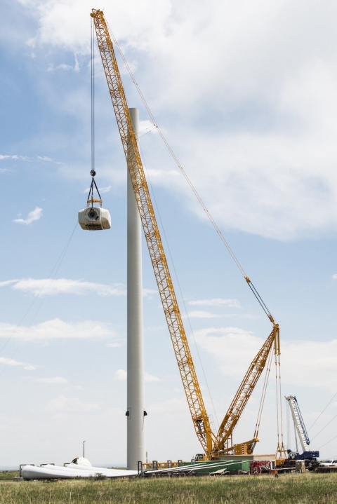A crane removes parts of a wind turbine.