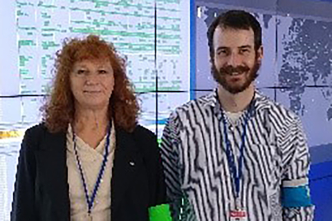 A man and a woman standing in a control room.