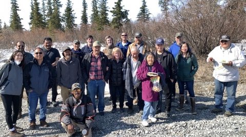 Dr. Richmond stands outside among residents of the Village of Noatak in Alaska 