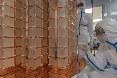 A research scientist examines the CUORE detector, an array of thousand crystals made of a material designed for the rare event searches. CUORE is located 4,500 feet underground at the Gran Sasso National Laboratory in Italy.