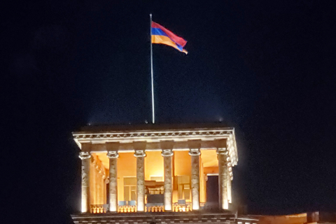 An Armenian flag flying on top of a tower.