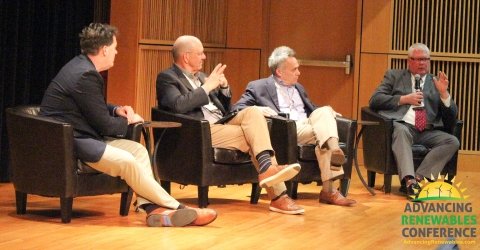 four male presenters sitting on a panel discussion