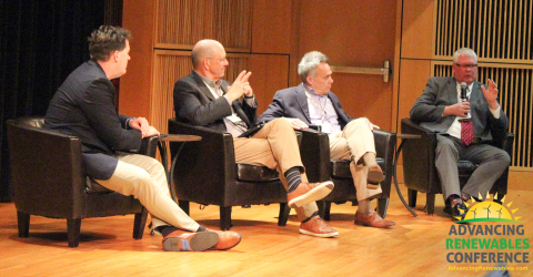 four male presenters sitting on a panel discussion