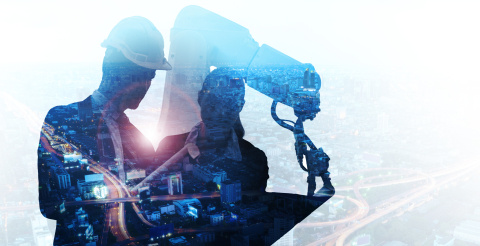A photo outline of two workers overlaid with a futuristic view of a computer.