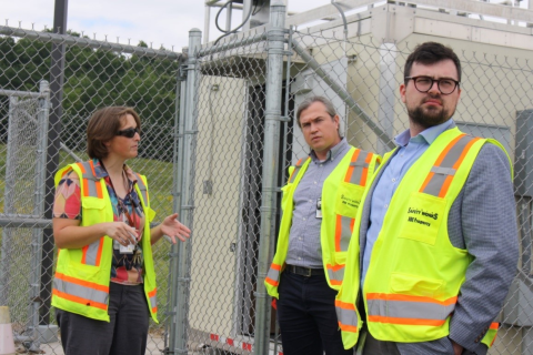 Site supervisor explaining air monitors in background