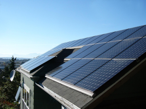 Solar panels on a roof with blue sky above