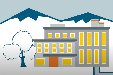 Cartoon building with a tree next to it and mountains in the background.
