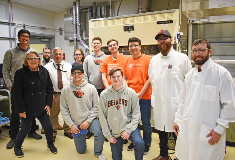A group of college students pose for a picture in a laboratory 