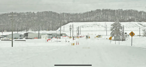 A snow covered road and facility building