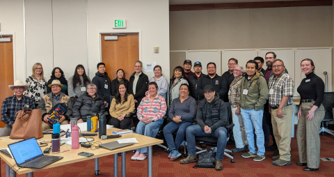 A large group of people posing for a picture in a conference room