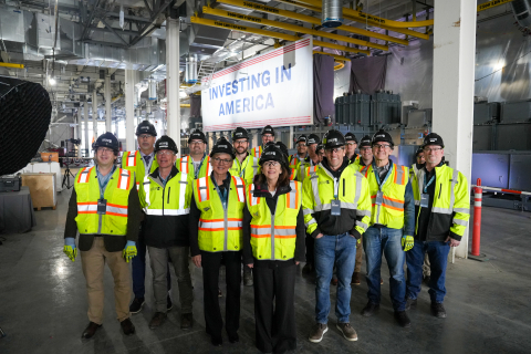 U.S. Energy Secretary Jennifer Granholm and Senator Maria Cantwell with the Group14 team in Moses Lake, WA. They stand in front of a giant white sign that reads INVESTING IN AMERICA.