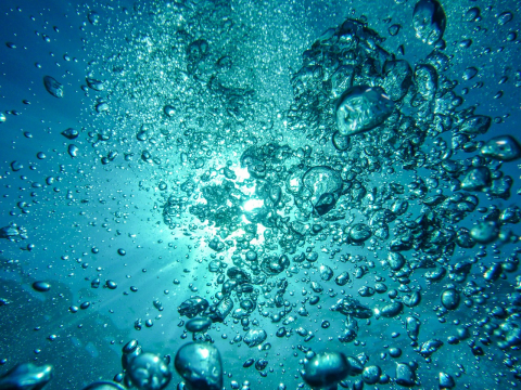 bubbles in water with light behind them