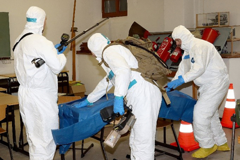 Three participants in the preparedness training in German donned protective suits before heading out.