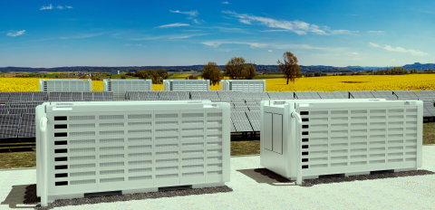 two large battery containers with a field of yellow in the foreground.  