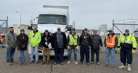 group of Hanford site employee's pose for a group picture in front of an 18-wheeler truck