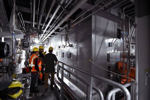 Workers inside a dark inside area of a melter