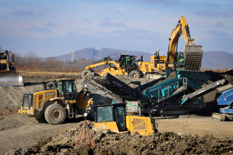Large, yellow equipment vehicles at a disposal facility 