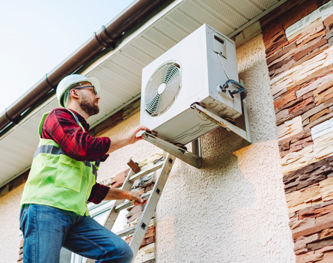 Technician installs heat pump