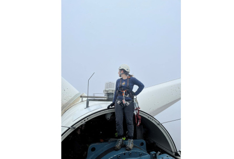 Annika Torp standing on turbine rotor, looking away from camera